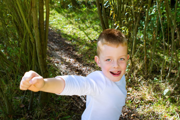 Little boy smiling in the woods