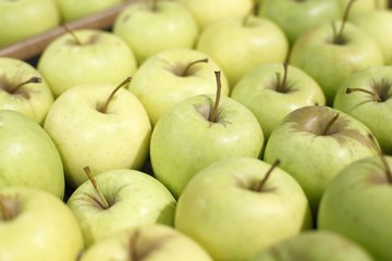 Appetizing green apples in supermarket