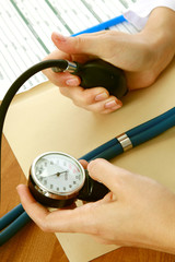 A doctor is measuring blood pressure with a tonometer
