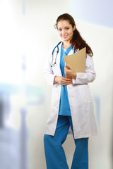 A portrait of a female doctor with a folder, indoors