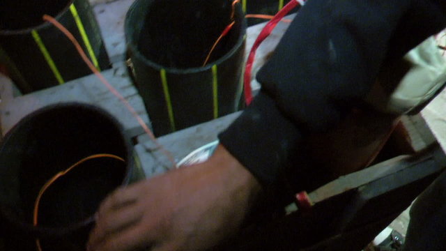 Pyrotechnicians wiring a pyro plant for a remote control