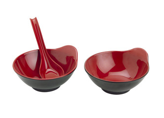 Two red bowl and spoon a soup bowl from Asia isolates