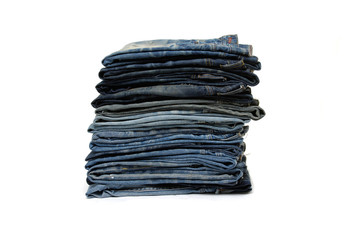 stack of various shades of blue jeans