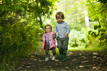 Siblings going for a walk on a path