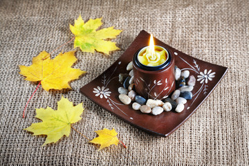Candle holder and yellow leaves