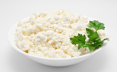 Fresh cottage cheese in the bowl isolated