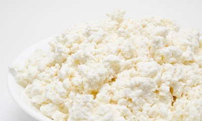 Fresh cottage cheese in the bowl isolated