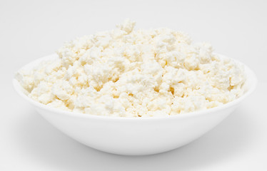 Fresh cottage cheese in the bowl isolated