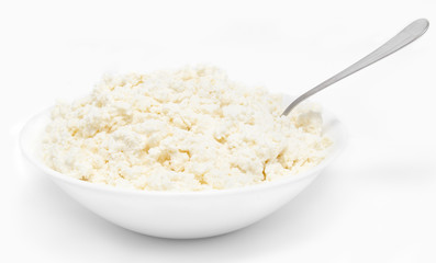 Fresh cottage cheese in the bowl with spoon isolated