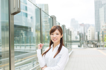 Beautiful business woman walking outside her office