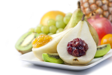 Fruits and pears with jam closeup luxury food concept on white