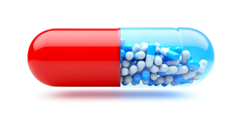 Big capsule with small capsules. Medicines concept.