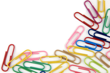 Multicolored paper clips on white background with space for text