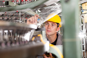 textile factory quality controller checking yarn