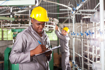 african american textile worker writing report