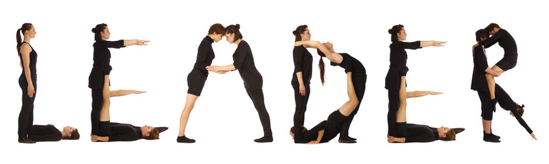 Black dressed people forming LEADER word over white