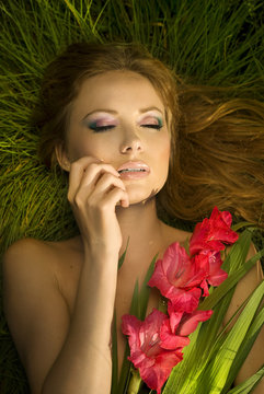 charming woman lying on colored flowers