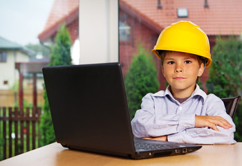 Portrait of handsome kid posing at home with computer
