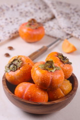 fresh persimmon on the wooden table