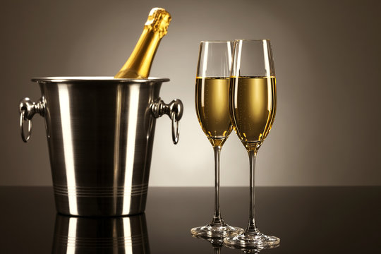 zwei gläser mit champagner mit einer flasche sekt