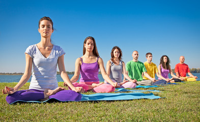 Group of young people have meditation on yoga class.