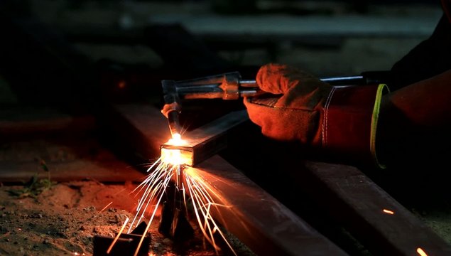 Gas cutting metal using acetylene torch