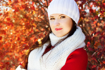 portrait of beautiful young woman in white winter clothes
