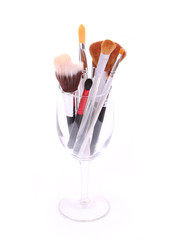 brushes for makeup in glass on white background