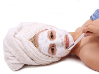 beautiful girl applying mask on face on white background