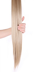 blonde hair extensions in female hand isolated