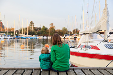 family sitting on pier