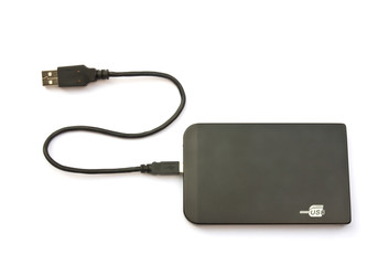 Portable external hard disk drive with USB cable on white backgr