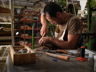 adult man working in a shoe factory