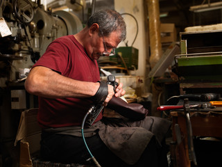 adult man working in a shoe factory