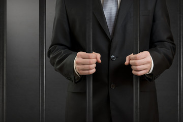 Businessman in jail close up