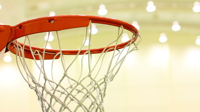 scoring basket in basketball court