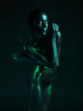 artistic nude of woman shiny blue skin