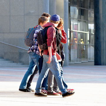 A group of young people walking on the background of the urban l