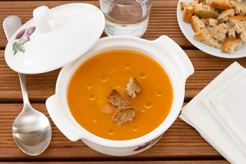 pumpkin soup in bowl with spoon