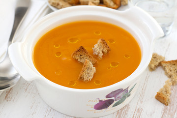 pumpkin soup in bowl with spoon