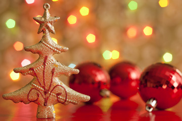 Christmas tree and baubles against blurred colorful background