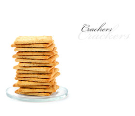 Pile of crackers on a small glass plate,  isolated on white with