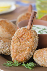 chicken cutlets on a stick of cinnamon with yogurt sauce