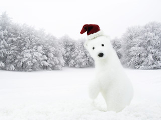 White bear with Santa hat in snowy field