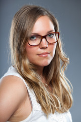 Fototapeta premium Pretty woman with long brown hair wearing glasses. Fashion.