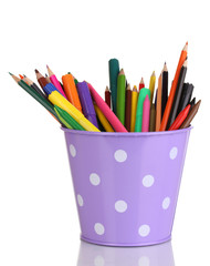 Colorful pencils and felt-tip pens in purple pail isolated