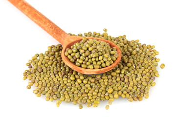 Mung beans over wooden spoon isolated on white