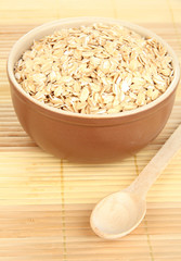 Brown bowl full of oat flakes