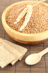 Wooden bowl full of wheat bran