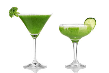 Green vegetable juice in coctail glass isolated on white